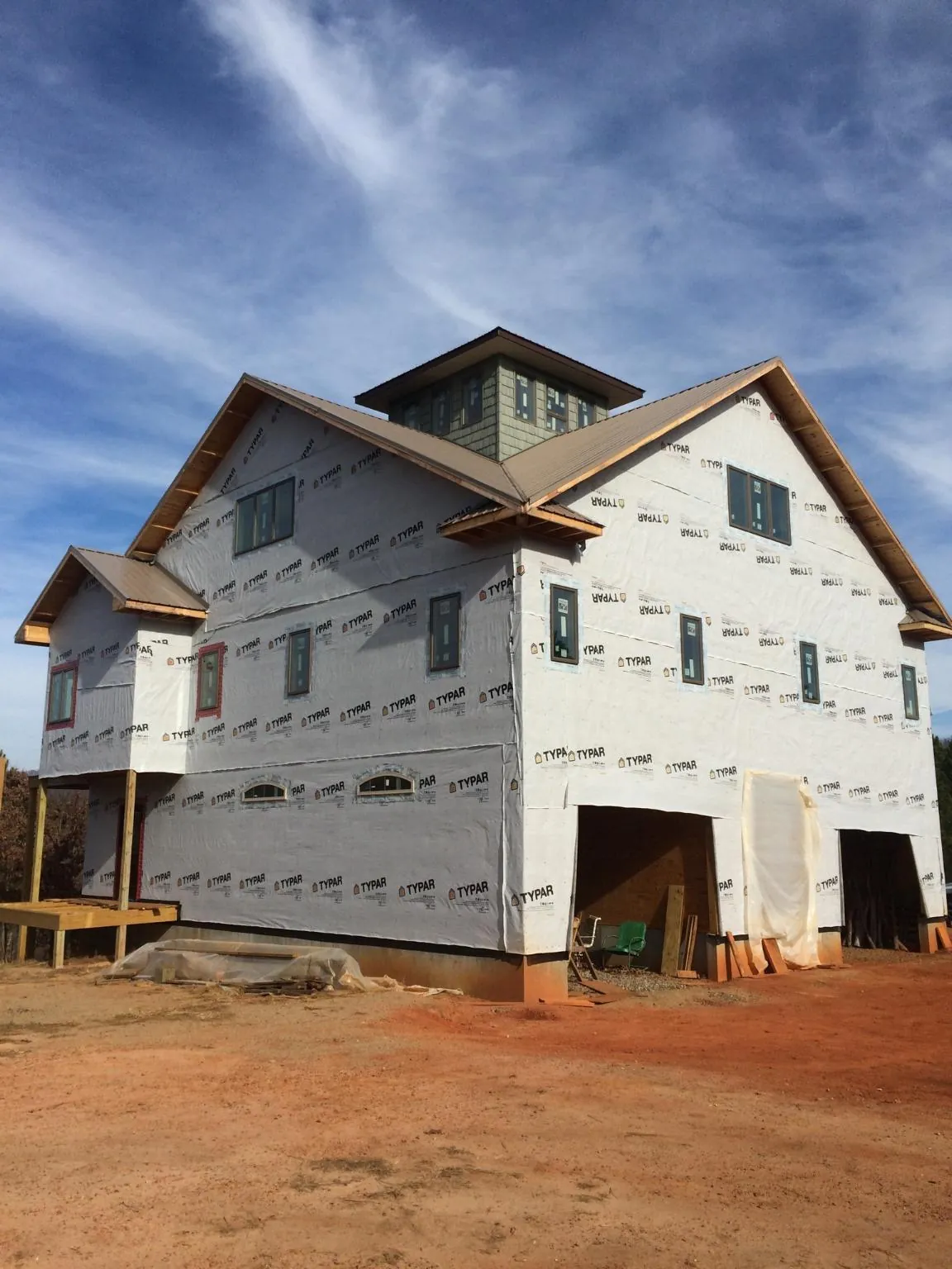 New two story house under construction with a cupola and gabled roofs in Dayton